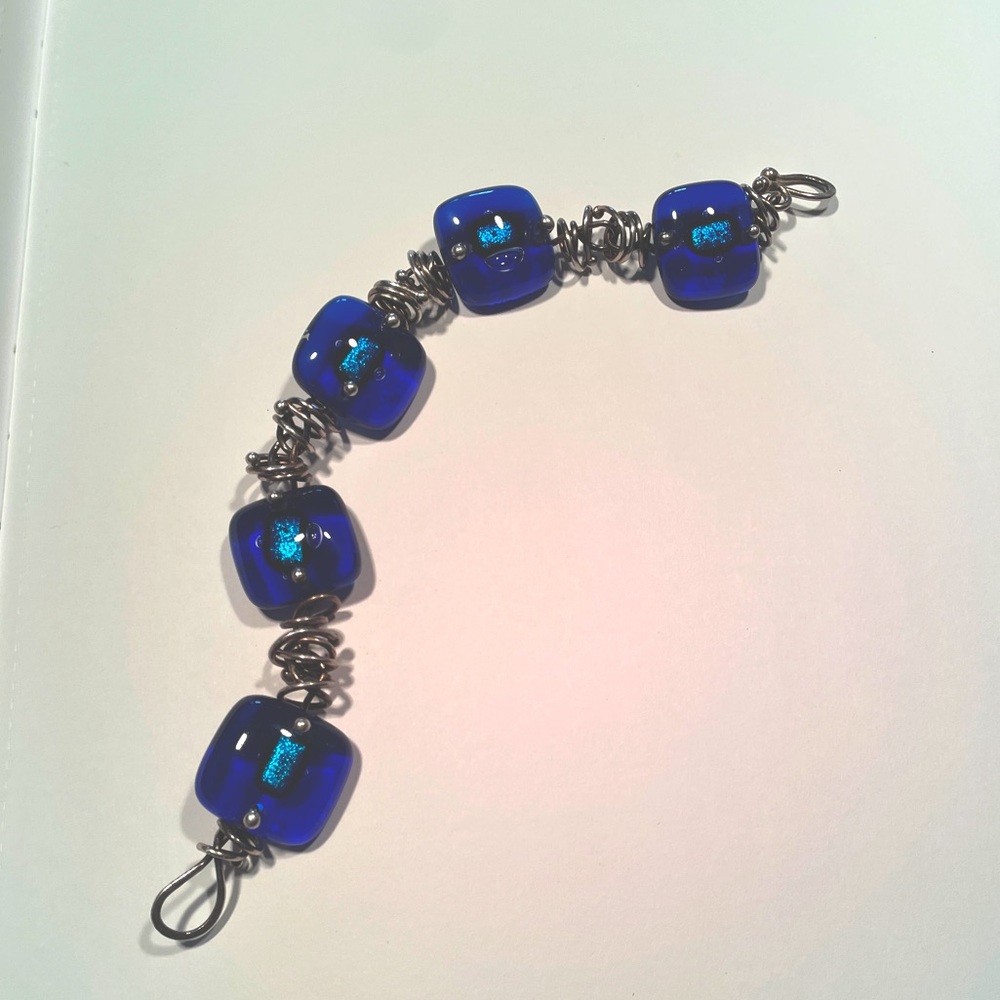 Handcrafted fused glass bead bracelet.